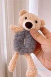 a brown teddy bear holding a brown teddy bear 